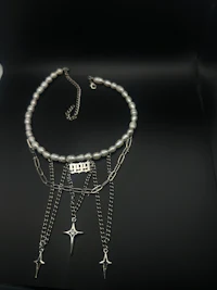 a silver necklace with a star on it