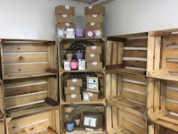 a wooden crate filled with candles and other items
