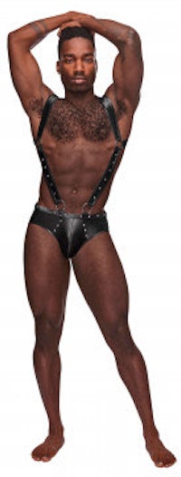 a man in black leather underwear posing on a white background