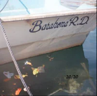 a boat in the water with a sign on it
