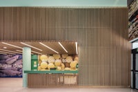 the interior of a supermarket with wooden slats