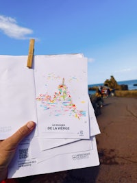 a person is holding a piece of paper with a map on it