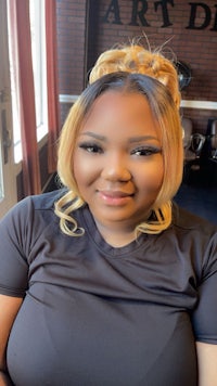 a woman in a black shirt smiling at the camera