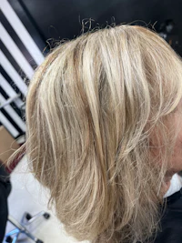 a woman with blonde hair in a salon