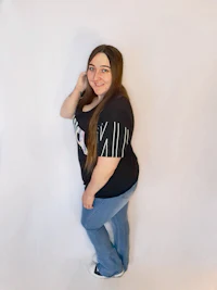 a woman is posing in front of a white background