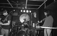 a group of people playing music in a black and white photo