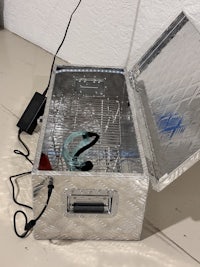 a silver box with a wire attached to it