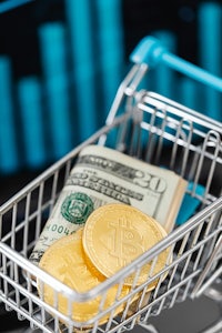 a shopping cart full of bitcoins in front of a graph
