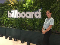 a woman standing in front of a billboard sign