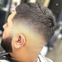a man with a beard and a fade haircut