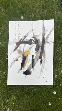 a piece of paper with black and yellow paint on it