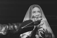 a bride with a veil and a ring on her finger