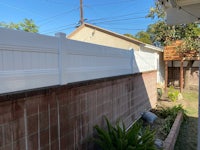 a white fence in the backyard of a house