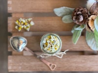 chamomile tea in a jar on a wooden table