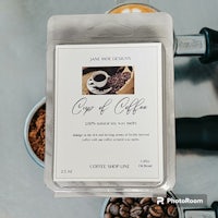 a candle with coffee beans on top of it