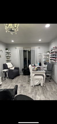 a room with a couch, chairs, and a chandelier