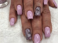 a woman's nails with purple and silver designs