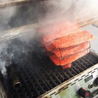 salmon on a grill with smoke coming out of it