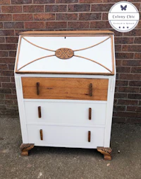a white and wood bureau with a wooden top