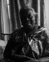 a black and white photo of a woman in a bed