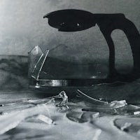 a black and white photo of a broken coffee pot