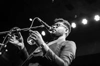 a man in glasses singing into a microphone