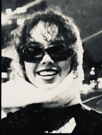 a black and white photo of a woman wearing sunglasses