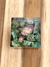 an amethyst crystal on a wooden surface