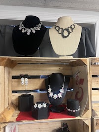 a display of necklaces and earrings in a crate