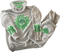 a gray sweatshirt and green sweatpants with a tree on them