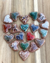 a heart shaped arrangement of stones on a wooden table