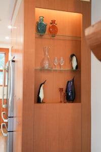 a wooden shelf with penguins on it