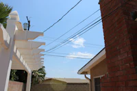 a white fence with a blue sky