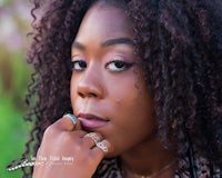 a woman with curly hair posing for a photo