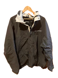 a black jacket hanging on a hanger