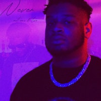 a man is standing in front of a purple light