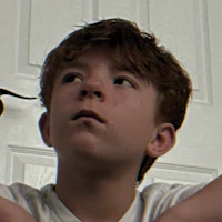 a boy wearing a white t-shirt