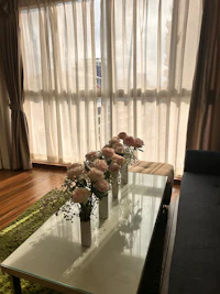 a glass table with flowers on it