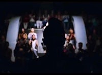 a silhouette of a woman standing in front of a crowd