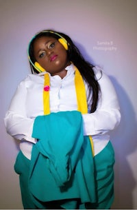 a woman in a blue and yellow outfit posing