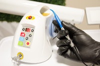 a person in black gloves is holding an electronic device