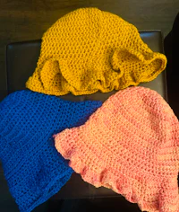 three crocheted hats on top of a table