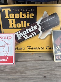 a collection of old signs on a wooden table