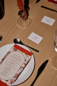 a white plate with a red napkin