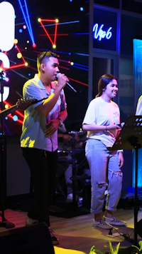 a man and a woman singing on stage