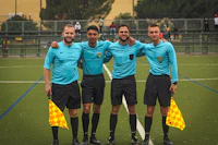a group of referees standing on a soccer field