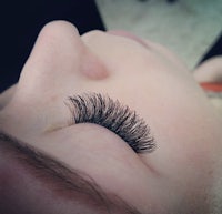 a close up of a woman's eye with long lashes