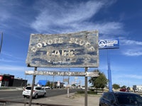 a sign for a cafe on the side of the road
