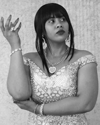 a black and white photo of a woman in a dress