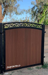 a wooden gate with an ornate design